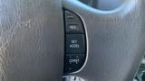 Close-up of the steering wheel controls of a 2013 Ford Econoline featuring buttons for cruise control settings including resume set accelerate and coast