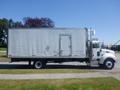 A white 2008 Peterbilt 335 box truck with a tall cargo compartment and a side door