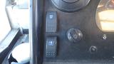 Dashboard controls of a 2006 Ford Econoline featuring buttons for mirror defrost and lights