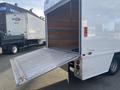 A white 2017 Mercedes-Benz Sprinter with an open rear door and ramp extended ready for loading or unloading items