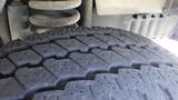 Close-up of a tire from a 2011 Ford Econoline showing tread patterns and tire details