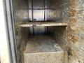 Interior view of a 2010 Ford F-550 truck bed with a metal frame and two shelves showing a weathered surface