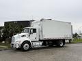 A white 2017 Kenworth T370 box truck with a cargo area and dual rear wheels parked on a concrete surface