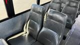 Interior view of a 2014 Freightliner Thomas Bus Diesel showcasing gray vinyl seating with a streamlined design and textured upholstery