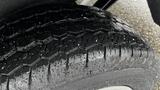 Close-up of a wet tire showcasing a detailed tread pattern on a 2012 Ford Transit