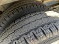 Close-up of two worn tires with visible tread patterns and slight debris on the surface