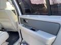 Interior view of a 2013 Ford Expedition showing the driver's side door panel with armrest and window controls