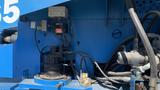 A close-up view of the engine compartment of a 2008 Genie S-65 Boom Lift showing various mechanical components and wiring