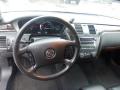 Interior of a 2008 Cadillac Limousine featuring a leather steering wheel dashboard with gauges and a stereo system