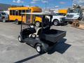 A 2017 Yamaha Golf Cart G29 E with a black body and beige seats features a rear cargo bed and a steering wheel visible in the front cabin