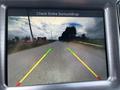 A 2017 Dodge Challenger being viewed from a rear camera display with guidelines indicating the path ahead