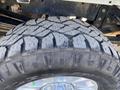 Close-up of a large, rugged tire from a 2019 Ford F-350 SD showing deep treads and a shiny alloy wheel