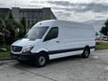 A 2016 Mercedes-Benz Sprinter cargo van with a high roof and sliding side door parked diagonally