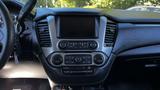 Interior dashboard of a 2018 Chevrolet Tahoe featuring a central console with climate control buttons and a touchscreen display