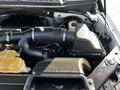 An engine compartment of a 2017 Ford F-150 showing the air intake system and various engine components