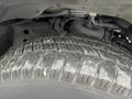 Close-up of a worn tire on a 2017 Chevrolet Express showing deep treads and visible dirt on the surface