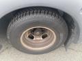 A close-up view of a tire and wheel from a 2017 Chevrolet Express showing the tread pattern and rusty wheel rim