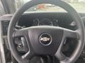 Steering wheel of a 2017 Chevrolet Express with controls and dashboard gauges visible in the background