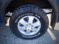 A close-up of a silver wheel with a rugged black tire on a 2017 Mercedes-Benz Sprinter showcasing the Goodyear All-Terrain T/A tread design