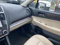 Interior view of a 2019 Subaru Outback showing the dashboard with controls and beige leather seats