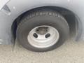 A close-up of the wheel and tire of a 2017 Chevrolet Express showing the tire tread and wheel rim