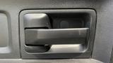 A black interior door handle of a 2013 RAM 2500