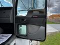 The image shows the open driver's door of a 2014 Kenworth T370 revealing the interior handle and control panel with a clear view of the lower window compartment