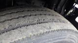 Close-up of a worn tire from a 2012 International TerraStar showing visible tread wear and cracks in the rubber