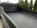 A 2005 GMC C5 Duramax truck bed with a textured black surface and slotted metal panel at the front