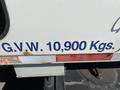 A side view of a 2010 Freightliner MT45 garbage truck with prominent lettering indicating a gross vehicle weight rating of 10,900 kilograms