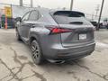 A gray 2021 Lexus NX 300 viewed from the rear showing its sleek design and distinctive taillights