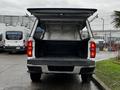 A 2019 Chevrolet Colorado with its tailgate lowered and bed visible showcasing the cargo area with a black liner and metallic surface