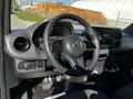 Interior view of a 2021 Mercedes-Benz Sprinter featuring a steering wheel dashboard controls and a central display