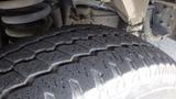 Close-up of a worn tire on a 2011 Ford Econoline showing detailed tread pattern and rubber texture