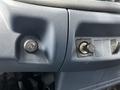 Close-up of the dashboard controls in a 2006 Hino 268 featuring throttle control and an ignition switch