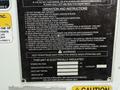 A black and yellow instruction label on a vehicle detailing operational guidelines safety warnings and electrical specifications