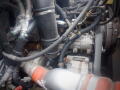 Close-up view of the engine components of a 2008 International 7400 including hoses and connectors