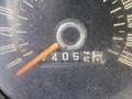 A close-up of the speedometer of a 1966 Ford Mustang displaying a needle pointing to 40 miles per hour with visible dirt and wear on the glass