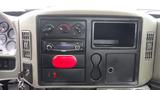 Dashboard of a 2010 International 4300 featuring instrument gauges audio system controls and storage compartments