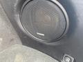 A black speaker with a mesh grille mounted in the trunk area of a 2019 Subaru Outback