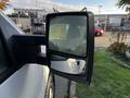 A side mirror of a 2008 Ford F-150 XL showing the reflection of the surrounding area