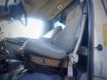 A driver’s seat from a 2006 Ford F-650 with a gray fabric cover and a sturdy seat frame