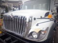 A 2008 International 7400 truck featuring a prominent chrome grille and large headlights with a white body