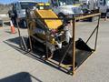 A yellow 2024 AGT KTT23 Mini Skid Steer enclosed in a metal frame with tracks and a front bucket attachment