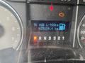 Dashboard display of a 2009 Ford F-150 showing average fuel consumption and total distance driven