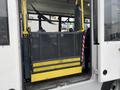 A wheelchair lift is deployed at the back of a 2017 Chevrolet Express, featuring a metal platform and safety mesh, designed for accessibility