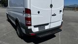 A 2016 Mercedes-Benz Sprinter van with a white exterior and a black bumper viewed from the rear angle