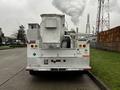 A white 2004 Ford F-450 SD with utility features and equipment mounted in the truck bed