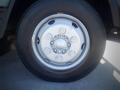 Close-up of a silver wheel with multiple bolts and a black tire from a 2013 Mitsubishi Fuso FE 160