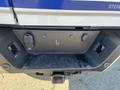 A 2019 Ford F-350 SD displaying a rear storage compartment with two recessed handles and ports for connections
